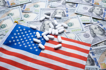 Tablets against the background of the dollar and the American flag.