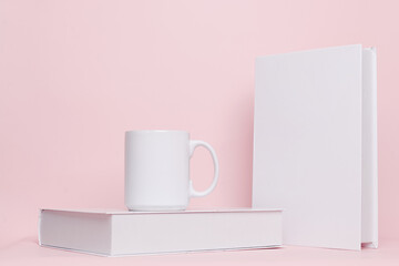 Mug and book combination for mock up isolated on pink background