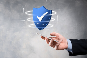 Businessman hold low poly polygon shield with a tick icon.Secure Access System Concept.Business...