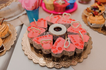 Sweet cakes at a wedding banquet. Catering, sweet festive buffet. Candy bar