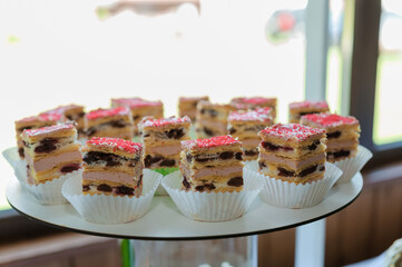 Sweet cakes at a wedding banquet. Catering, sweet festive buffet. Candy bar