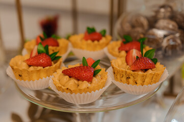 Sweet cakes at a wedding banquet. Catering, sweet festive buffet. Candy bar