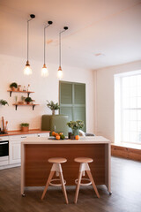 Modern Kitchen Interior with Island, Sink, Cabinets, and Big Window in New Luxury Home.