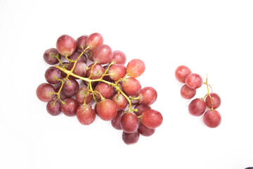 Red grapes placed on a white background, View from directly above.