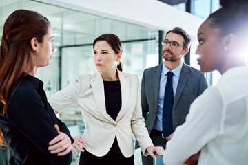 Confronting problems with colleagues is never a pleasant experience. Cropped shot of a group of...