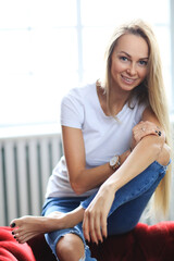 Happy blonde woman smiling at home