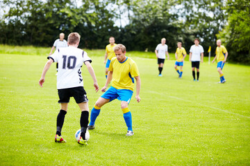 Playing good defense. A group of soccer players in the middle of a game.