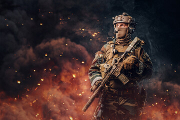 Military soldier dressed in uniform with rifle against flame - obrazy, fototapety, plakaty