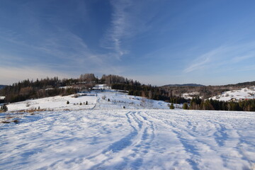 Fototapeta na wymiar Szlak górski w śniegu, błękitne niebo.