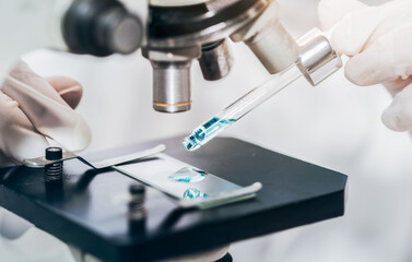 scientist with equipment and science experiments laboratory glassware containing chemical liquid....