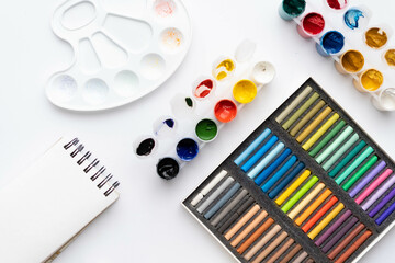 Flat composition set of artistic tools. Brushes, paints, pencils, pastels for drawing. Place for text.