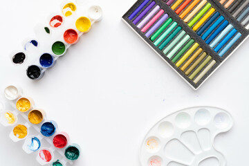 Flat composition set of artistic tools. Brushes, paints, pencils, pastels for drawing. Place for text.