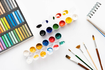 Flat composition set of artistic tools. Brushes, paints, pencils, pastels for drawing. Place for text.