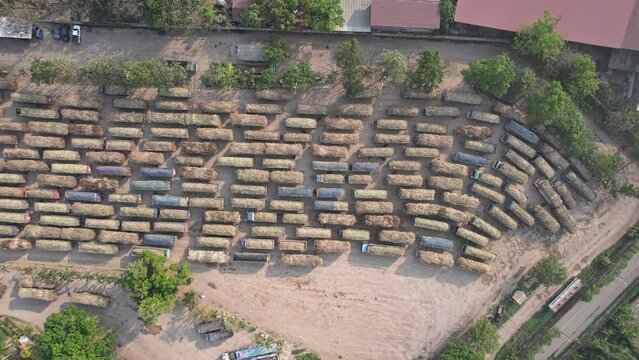 Group of sugarcane harvested truck parked queue to send the agricultural produce in industry processing plant area