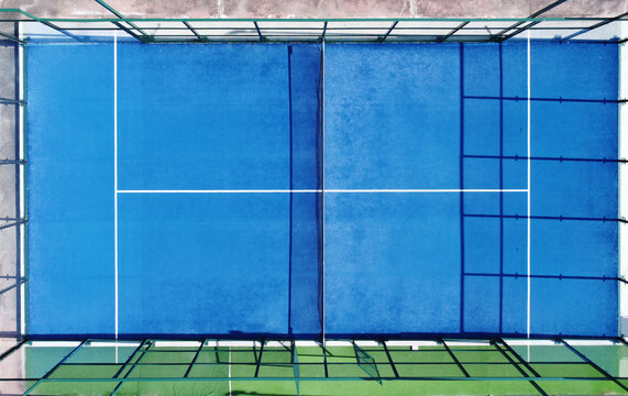 zenithal aerial drone image of a blue paddle tennis court