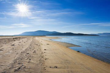Landscape at low tide, sandy estuary and mountains, Tanamunningen nature reserve in the mouth of the Teno aka Tana river, Finnmark, Norway
