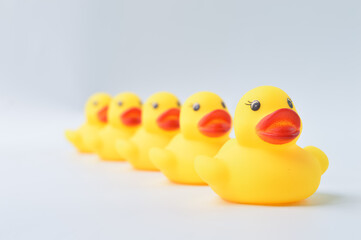 Toy ducks standing together in a row. Teamwork and integration concept.