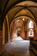 Fototapeta na wymiar Gothic arched vault gallery in Malbork Castle