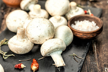 Fresh champignons with spices and herbs. Raw ingredient for cooking vegan food