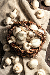 Fresh champignons in a basket. Raw ingredient for cooking vegan food
