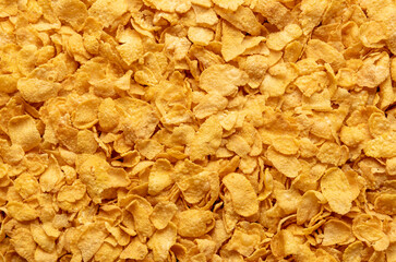Cornflakes background, top view. Corn cereals texture.