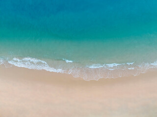 Aerial view Perspective of Waves and Beach from top view. Blue water background by drone.