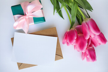 beautiful bouquet of pink tulips and a gift box with a pink bow 