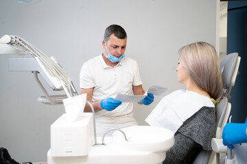 small conversation between a patient and a dentist, preparing for a dental checkup in a dental office. Regular visits to the orthodontist.