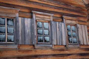 Traditional wooden house windows of Russia Siberia Shutters glass. Frozen glass.