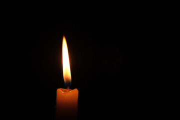 Flame burning candle black background.Concept memory and sorrow.