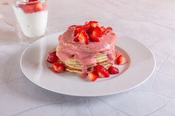 Strawberry pancakes on a white background.