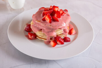 Strawberry pancakes on a white background.