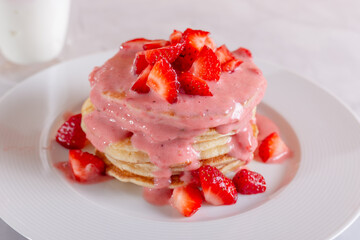 Strawberry pancakes on a white background.