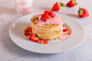 Strawberry pancakes on a white background.