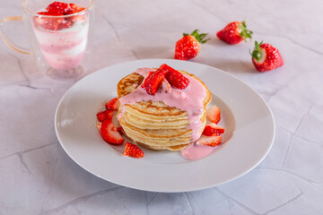 Strawberry pancakes on a white background.