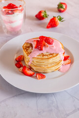 Strawberry pancakes on a white background.