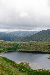 Fototapeta na wymiar Beautiful landscape panorama of Pyg Track near Miners Track in Snowdonia National Park in North Wales, UK. Shoot during cloudy day