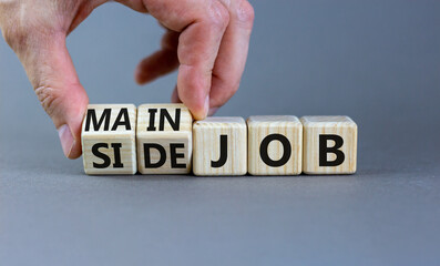 Extra or side job symbol. Businessman turns wooden cubes and changes concept words Side job to Main...
