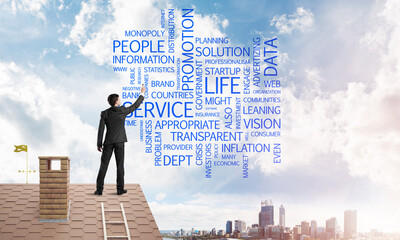 Young businessman standing on house roof and writing leadership skill concept. Mixed media