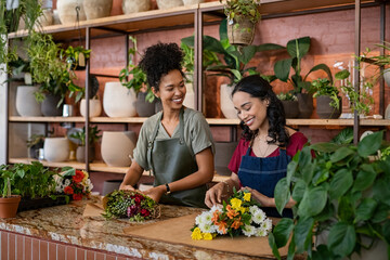 Two multiethnic women working in florist shop together - 492004875