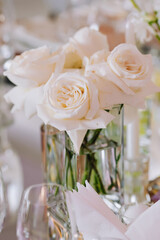 Wedding table decor in white green tones. Wedding table set up in boho style with pampas grass and greenery, soft focus.