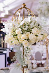 Wedding table decor in white green tones. Wedding table set up in boho style with pampas grass and greenery, soft focus.