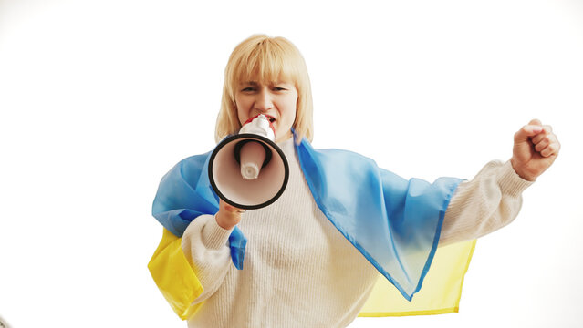 Angry Woman protesting with a megaphone and Ukrainian Flag. . High quality photo