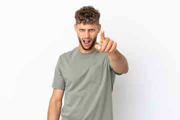 Young caucasian handsome man isolated on white background frustrated and pointing to the front