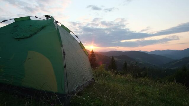 Beautiful sunset on the mountains of the Swiss Alps, view with a tent. 