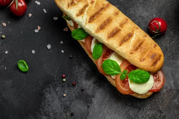 Fototapeten Pressed and toasted panini caprese with tomato, mozzarella and basil, Caprese Panini Sandwich. Delicious breakfast or snack, Clean eating, dieting, vegan food concept. top view © Надія Коваль