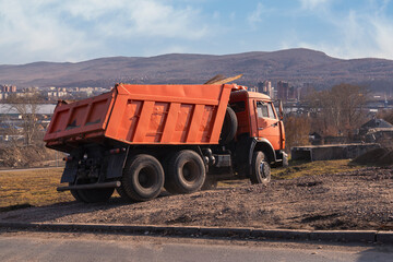 Dump truck works on the construction of a road junction