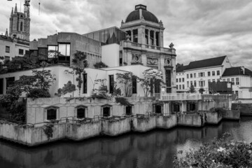 Moody black and white daytime travel photograph from the historical center of Gent, Belgium. Cloudy sky.