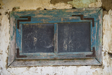 Sunja, Croatia, April 20,2021 : Rustic style aged window at rural home wall.