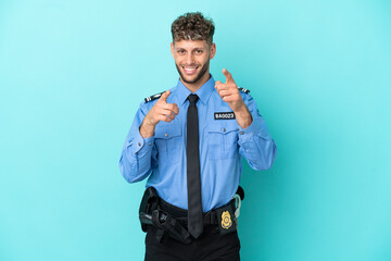 Fototapeta premium Young police blonde man isolated white on blue background points finger at you while smiling
